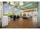 Expansive clubhouse area with modern lighting, wood flooring, large windows and comfortable seating for a relaxing atmosphere at 11419 Gallatin Trl, Parrish, FL 34219