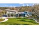 Community center featuring a modern architectural design, complemented by green lawns and trees at 11419 Gallatin Trl, Parrish, FL 34219