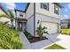 Inviting two-story home featuring a well-kept lawn, lush tropical landscaping, and a convenient two-car garage at 11419 Gallatin Trl, Parrish, FL 34219
