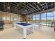 Game room features several pool tables, a television and large windows with views of the exterior at 11419 Gallatin Trl, Parrish, FL 34219