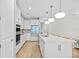 Spacious white kitchen features an island with bar seating and modern appliances at 11419 Gallatin Trl, Parrish, FL 34219