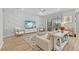 Bright living room with decorative wall and sliding glass doors to the patio at 11419 Gallatin Trl, Parrish, FL 34219