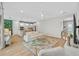 Spacious living room open to kitchen with white cabinets and an island with bar seating at 11419 Gallatin Trl, Parrish, FL 34219