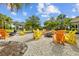 Inviting outdoor gathering space with colorful Adirondack chairs surrounding a fire pit, ideal for community engagement at 11419 Gallatin Trl, Parrish, FL 34219