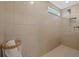 Tiled walk-in shower with a built-in niche and handheld shower head, offering a modern and relaxing experience at 11419 Gallatin Trl, Parrish, FL 34219