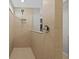 Sleek walk-in shower with beige tiling, a modern showerhead, and a clear glass partition for a clean aesthetic at 11419 Gallatin Trl, Parrish, FL 34219