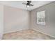 Bedroom featuring neutral walls, tiled floors, and a ceiling fan for added comfort at 11734 Winding Woods Way, Lakewood Ranch, FL 34202