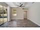 Bright bedroom with wood floors, a ceiling fan, and sliding doors to the outdoor pool area at 11734 Winding Woods Way, Lakewood Ranch, FL 34202