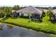 Inviting backyard featuring a screened lanai and tranquil water view at 12019 Sawgrass Lake Ter, Bradenton, FL 34211