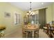 Cozy dining area with bright natural light, a chandelier, and charming decor at 12019 Sawgrass Lake Ter, Bradenton, FL 34211