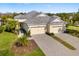 Charming home with well-manicured landscaping and a spacious three-car garage at 12019 Sawgrass Lake Ter, Bradenton, FL 34211