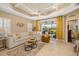 Bright living room with large windows, tray ceiling and stylish décor at 12019 Sawgrass Lake Ter, Bradenton, FL 34211