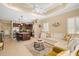 Open-concept living space featuring a kitchen island, a comfortable sofa, and natural light at 12019 Sawgrass Lake Ter, Bradenton, FL 34211