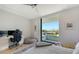 Modern bedroom with a desk, chair, beanbag, and a large window with a view of the neighborhood at 1339 Westway Dr, Sarasota, FL 34236