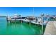 A private boat dock featuring multiple boats, boatlifts and a clear view of the sparkling ocean at 1339 Westway Dr, Sarasota, FL 34236