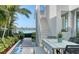 View of outdoor patio featuring a dining table and stairs to a rooftop deck overlooking the water at 1339 Westway Dr, Sarasota, FL 34236