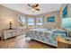 Bright bedroom with bay windows, a queen-size bed, and coastal-themed decor at 1620 Fairway Trce # B, Palmetto, FL 34221