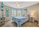 Comfortable bedroom with a queen bed, tile floors, and bright natural light at 1620 Fairway Trce # B, Palmetto, FL 34221