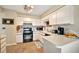 Efficient kitchen features white cabinets, tile floors, and essential appliances at 1620 Fairway Trce # B, Palmetto, FL 34221