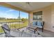 Inviting screened lanai offers comfortable seating and serene views of the golf course and water at 1620 Fairway Trce # B, Palmetto, FL 34221