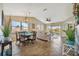 Open living space includes a dining area and a seating area with access to a screened in lanai at 1620 Fairway Trce # B, Palmetto, FL 34221