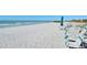 Picture of the beautiful, sandy beach with turquoise beach chairs at 1945 Gulf Of Mexico Dr # M2-206, Longboat Key, FL 34228