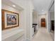 Hallway view showcasing an arched entrance, artwork, and desk, providing a sense of depth at 20010 71St E Ave, Bradenton, FL 34211