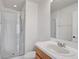 Bathroom featuring a glass-enclosed shower, vanity with sink, and a toilet at 208 Cape Harbour Loop # 108, Bradenton, FL 34212
