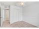 Cozy bedroom with carpet, ceiling fan, a closet, and an entrance to the bathroom at 208 Cape Harbour Loop # 108, Bradenton, FL 34212