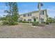 The exterior of this home showcases green accents, a walkway, and manicured landscaping at 208 Cape Harbour Loop # 108, Bradenton, FL 34212