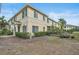 This home boasts a two-story exterior with green shutters and manicured landscaping at 208 Cape Harbour Loop # 108, Bradenton, FL 34212