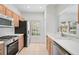 Bright kitchen featuring stainless steel appliances, wood cabinets, and plenty of natural light from the window at 208 Cape Harbour Loop # 108, Bradenton, FL 34212