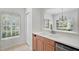 Bright kitchen featuring stainless steel appliances, a white countertop, and a window with natural light at 208 Cape Harbour Loop # 108, Bradenton, FL 34212