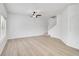 Bright living room featuring vinyl flooring, stairs leading upstairs, and a modern ceiling fan at 208 Cape Harbour Loop # 108, Bradenton, FL 34212