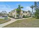 Charming townhouse exterior featuring well-maintained lawns and lush landscaping, creating a welcoming curb appeal at 208 Cape Harbour Loop # 108, Bradenton, FL 34212