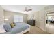 Bright bedroom featuring a dresser, carpet flooring, and ceiling fan at 209 111Th E St, Bradenton, FL 34212