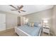 Comfortable bedroom with a closet, soft lighting from side lamps, and a ceiling fan at 209 111Th E St, Bradenton, FL 34212