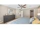 Bedroom with a gray dresser, carpet flooring, and ceiling fan at 209 111Th E St, Bradenton, FL 34212