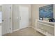 Welcoming foyer with neutral tile flooring, a console table with decor, and a pristine white front door at 209 111Th E St, Bradenton, FL 34212