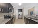 Modern kitchen with stainless steel appliances and granite countertops at 209 111Th E St, Bradenton, FL 34212