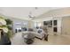 Open-concept living room with neutral tones, modern furnishings, and views of the outdoor pool area at 209 111Th E St, Bradenton, FL 34212