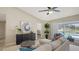 Open-concept living room with neutral tones, modern furnishings, and access to a pool view and backyard at 209 111Th E St, Bradenton, FL 34212