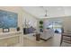 Cozy living room with vaulted ceiling, a ceiling fan, decor, and view of the beautiful outdoor pool area at 209 111Th E St, Bradenton, FL 34212