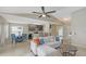 Open concept living room adjacent to a kitchen and dining area, featuring natural light at 209 111Th E St, Bradenton, FL 34212