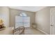 Bright office space featuring a large window, neutral walls, a stylish desk, and comfortable wicker chairs at 209 111Th E St, Bradenton, FL 34212