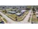Aerial view of a neighborhood featuring diverse home styles, manicured lawns, and calm residential streets at 211 Dalton Blvd, Port Charlotte, FL 33952