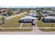 Single-story home showcasing front lawn, long driveway, and a light-grey roof at 211 Dalton Blvd, Port Charlotte, FL 33952
