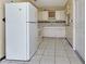 Well lit kitchen area with white appliances and tile backsplash at 211 Dalton Blvd, Port Charlotte, FL 33952