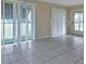 Bright living room with tile floors, vertical blinds and sliding glass door at 211 Dalton Blvd, Port Charlotte, FL 33952