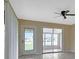 Bright living room featuring tile floors, ceiling fan, and access to an outdoor patio with sliding glass doors at 211 Dalton Blvd, Port Charlotte, FL 33952
